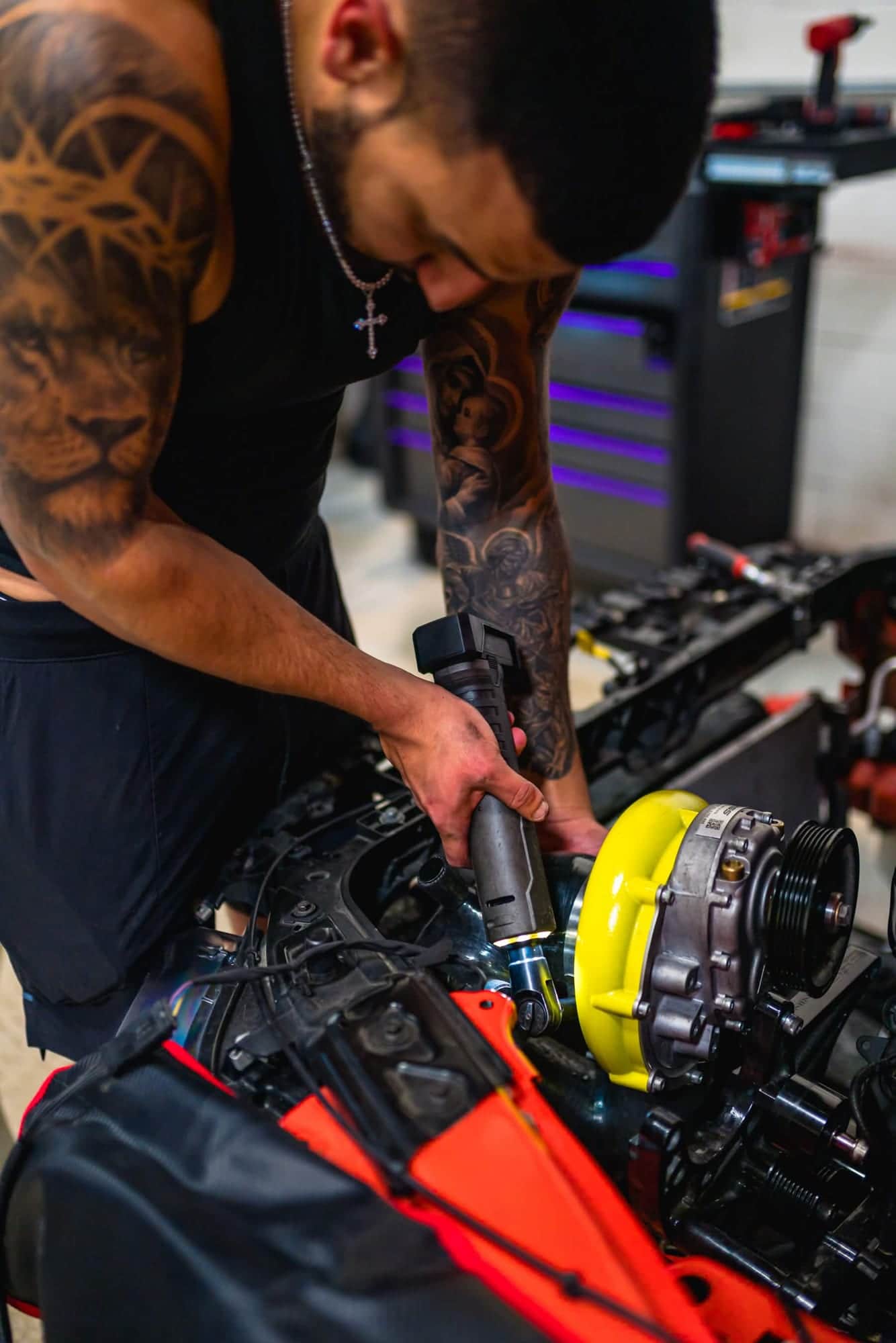 Norik tightening a clamp on a supercharger inlet with a cordless ratchet