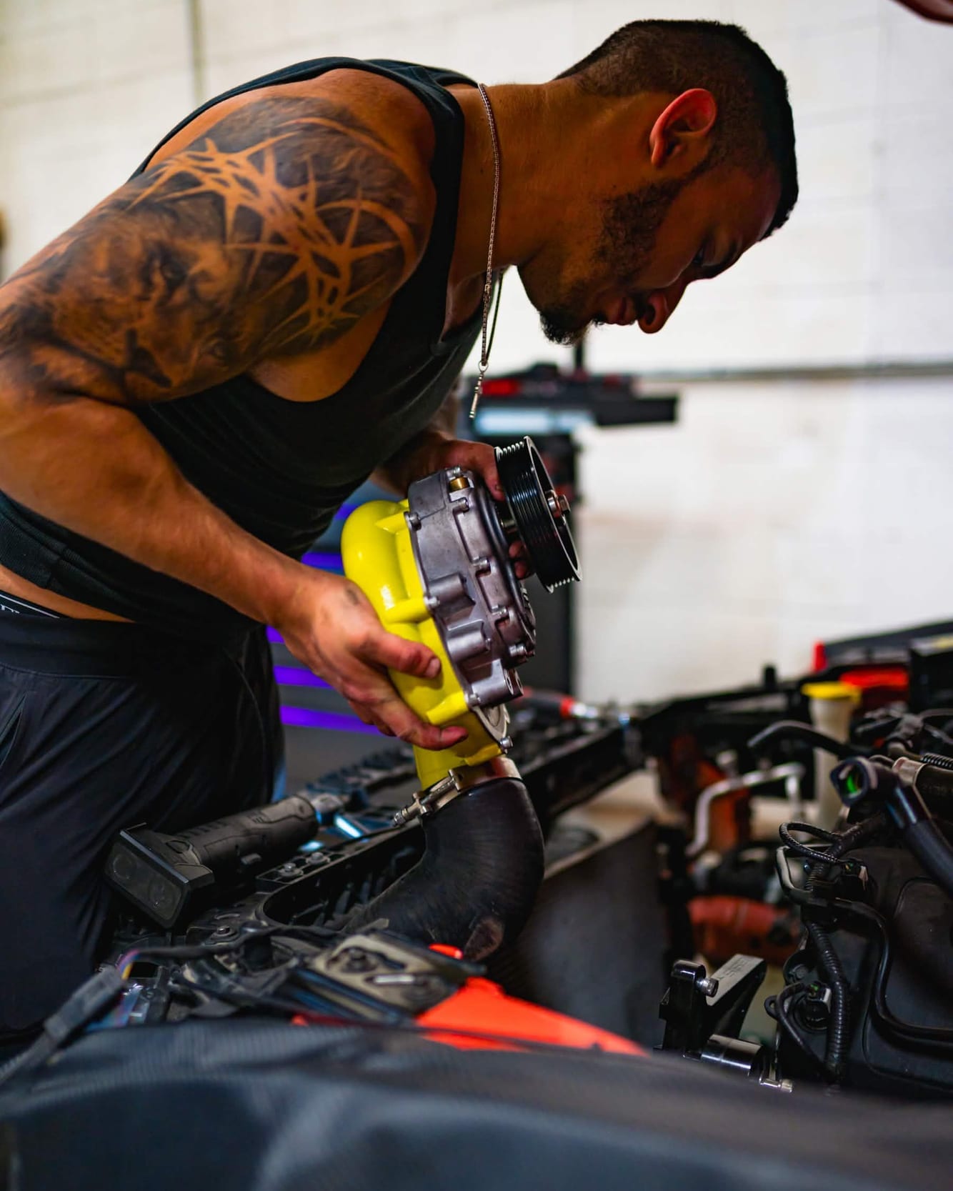 Norik, founder of Noro Performance, fitting a supercharger in the shop
